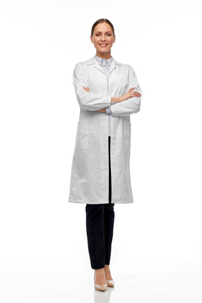 smiling female doctor or scientist in white coat - Fotó, kép