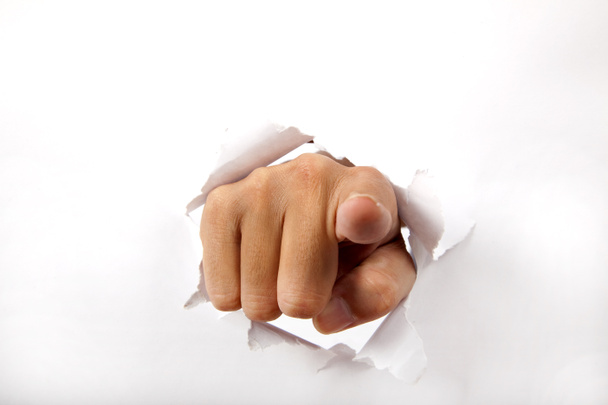 Romper la mano a través del papel blanco
 - Foto, Imagen