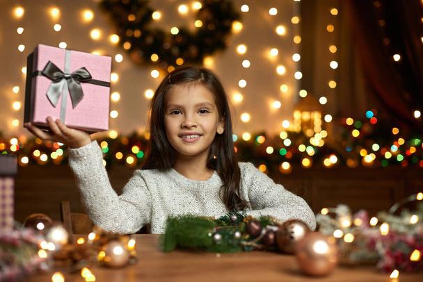 little child girl holding Christmas gift box - 写真・画像