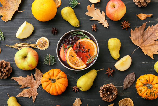 Autumn composition with bowl of hot mulled wine on dark wooden background - Fotografie, Obrázek