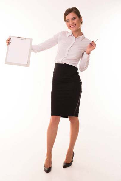 Girl in a skirt and blouse stands with a tablet. - Photo, image
