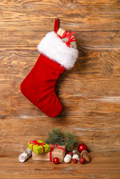 Composition with Christmas sock on wooden background - Photo, Image