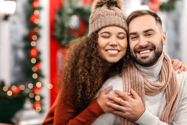 Happy young couple celebrating Christmas outdoors - Foto, afbeelding