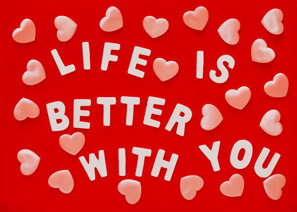 Valentijnsdag rode achtergrond met roze harten en zin Life Is Better With You bekleed met witte houten letters.Mother 's Day, 8 maart wenskaart - Foto, afbeelding