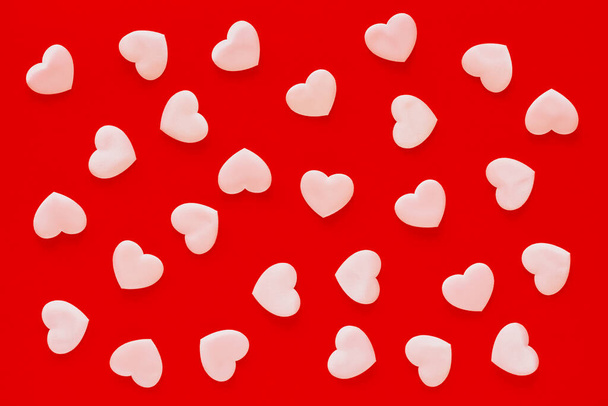 Valentine's Day red background with pink hearts. Valentine's Day pattern, Mother's Day, March 8 greeting card. - 写真・画像