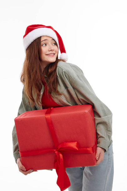 girl with red big gift box in hands studio light background cropped view - Photo, Image