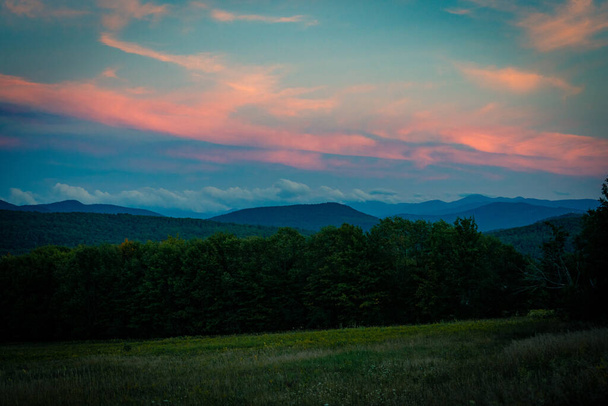 SARANAC LAKE, UNITED STATES - Sep 06, 2020: The sun sets over the Adirondack Mountains near Saranac Lake, New York - Фото, изображение