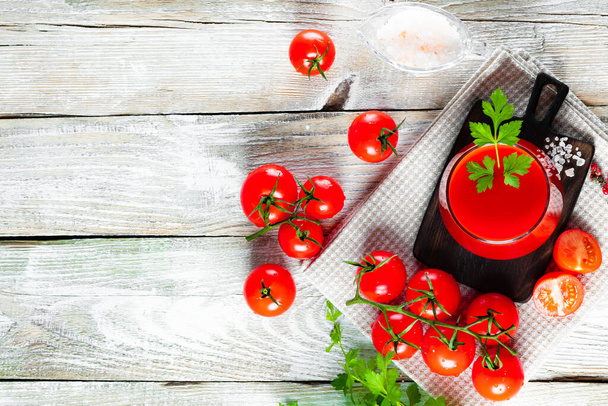  Lasi tuoretta tomaattimehua puupohjalla, vapaata tilaa tekstillesi. Laadukas kuva - Valokuva, kuva