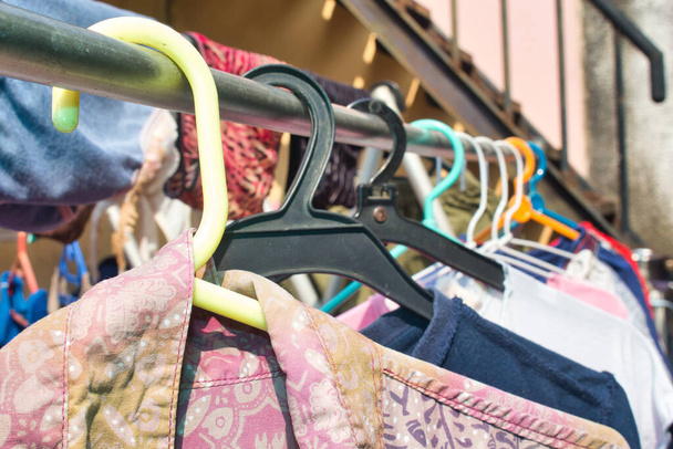 A closeup shot of colorful clothes on the hangers - Fotó, kép