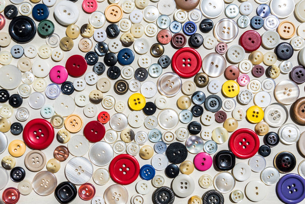 A high angle shot of a bunch of colorful decorative buttons - Foto, afbeelding