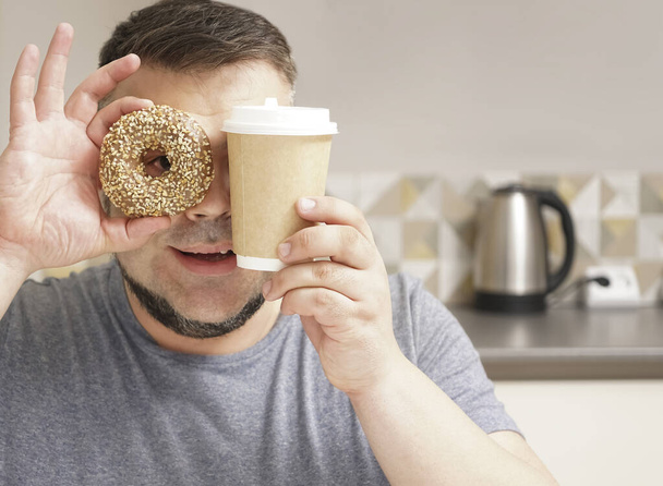 Sweet life.  bearded man on kitchen background.  mature man.    donut dessert and coffee cup. chocolate doughnut. temptation while diet. - Zdjęcie, obraz