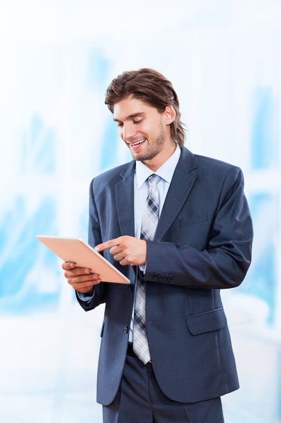 Business man holds tablet pad - Photo, image
