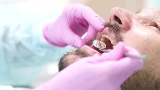 Middle-aged man with mustache and beard at the dentists appointment - Filmmaterial, Video