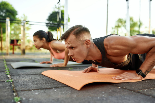 Young caucasian man training oudoors pushing up on mats - Zdjęcie, obraz