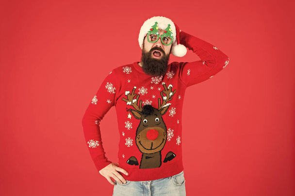 Knitted sweater. Happy new year. Christmas spirit. Winter party outfit. Sweater with deer. Clothes shop. Buy festive clothing. Holidays accessories. Hipster bearded man wear winter sweater and hat - Foto, immagini