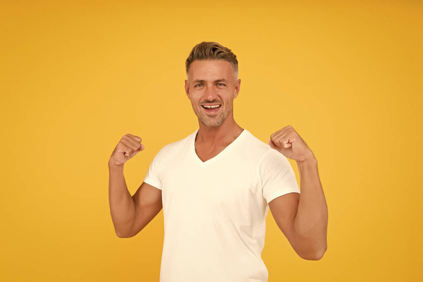 Strength and power. Happy bachelor show strength. Strong man flex arms yellow background. Strength and confident. Strength comes from within - Фото, зображення