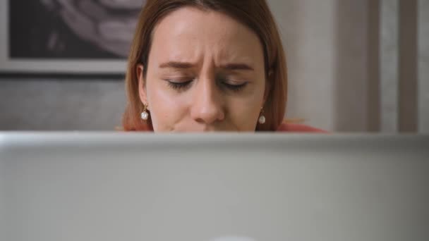 Close up worried sad businesswoman face looking at laptop at the home office. Close up of upset woman thinking about mistakes in work. Portrait of sad girl looking laptop. Depressed employee working - Footage, Video