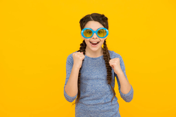 life is party. trendy summer vacation accessory. beauty and fashion. child in sunglasses. happy childhood. wearing casual glasses. cheerful teenage girl. pretty kid with braided brunette hair - Fotó, kép