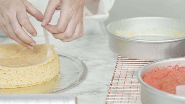 Step by step. Removing freshly baked cake layers from the cake pan to be cooled. - Photo, Image