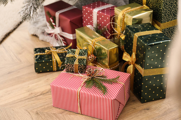 Many different Christmas gifts on floor indoors - Φωτογραφία, εικόνα