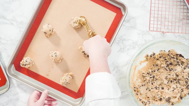 Step by step. Flat lay. Scooping homemade chocolate chip cookies with metal dough scoop to the baking sheet. - Foto, Imagem