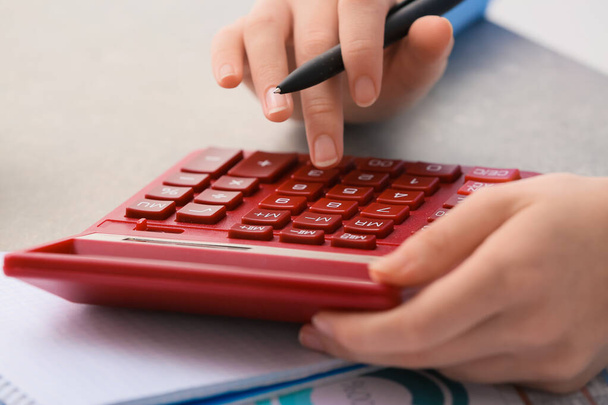Female accountant with calculator working in office, closeup - Photo, Image