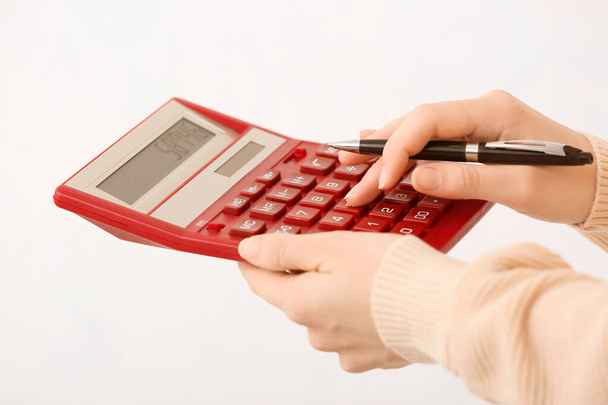 Female accountant with calculator on white background - Photo, Image