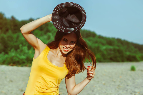 девушка в шляпе и рубашке на закате - Фото, изображение