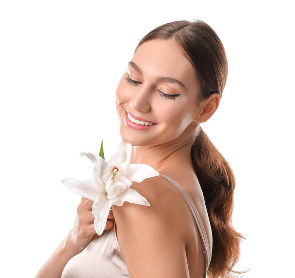 Beautiful young woman with fresh lily on white background - Photo, Image