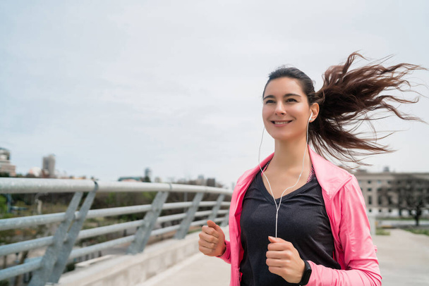 Portrait of fitness woman running. - 写真・画像