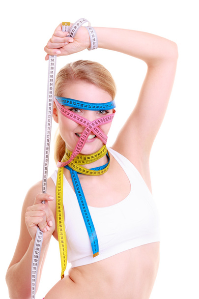Obsessed fitness woman with a lot of colorful measure tapes - Fotoğraf, Görsel