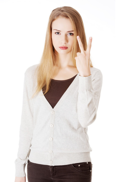 Woman is showing victory sign, two fingers. - 写真・画像