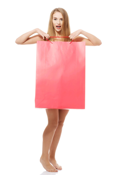 Naked beautiful woman holding shopiing bag. - Fotó, kép