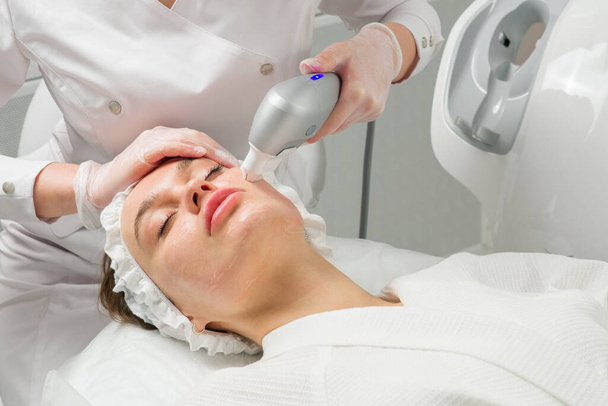 ultraformer lifting. Face Skin Care. Close-up Of Woman Getting Facial Hydro Microdermabrasion Peeling Treatment At Cosmetic Beauty Spa Clinic. Hydra Vacuum Cleaner. Exfoliation, Rejuvenation And - Photo, Image
