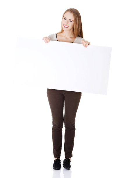 Woman holding copy space and advertising. - Foto, afbeelding