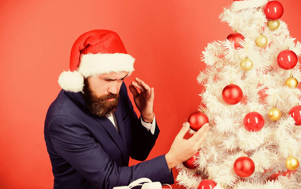 Perfectionist concept. Bearded Santa. Corporate party. Winter holidays. Perfect decorations. Man wear Santa Claus hat. Santa claus is coming to town. Getting ready. Everything should be shiny - Valokuva, kuva