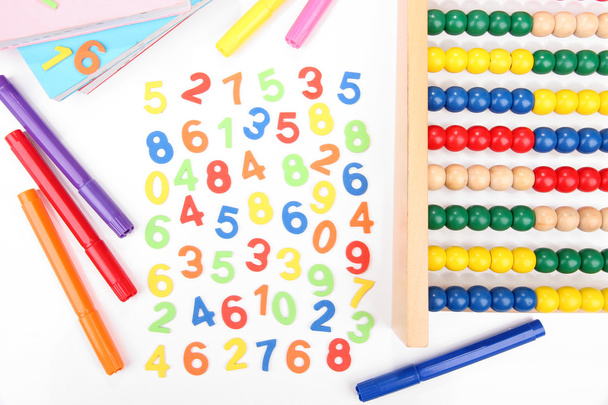 Colorful numbers, abacus, books and markers, isolated on white - Fotoğraf, Görsel