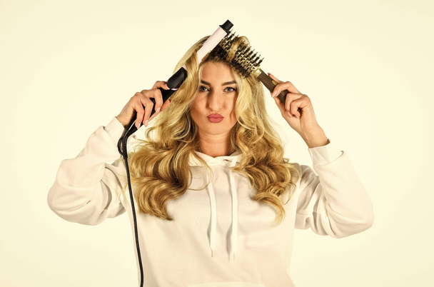 Online shop. Create hairstyle. Woman with long curly hair use curling iron. Hairdresser tips. Using different wrapping techniques. Choose right type curling iron for your needs. Girl adorable blonde - Фото, изображение