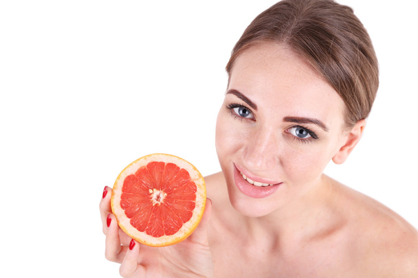 Beautiful young woman holding grapefruit, isolated on white - Photo, image