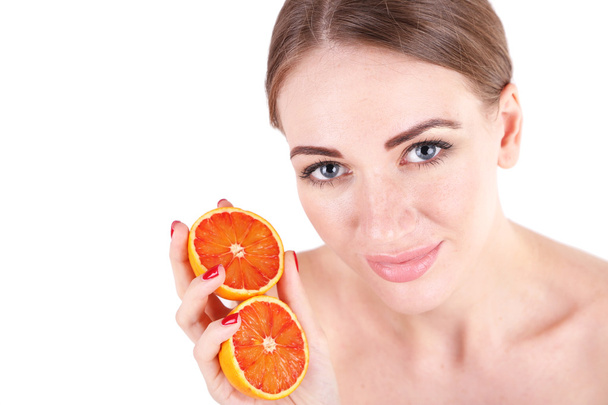 Beautiful young woman holding orange, isolated on white - Foto, afbeelding