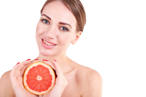 Beautiful young woman holding grapefruit, isolated on white - Foto, Bild