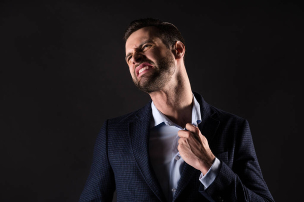 Close-up portrait of his he nice attractive tired irritated annoyed overwhelmed guy employer partner tearing shirt dislike employment fail fired isolated over dark black color background - Fotoğraf, Görsel