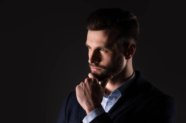 Close-up portrait of his he nice attractive minded man professional director agent broker touching chin thinking deciding solving isolated over dark black pastel color background - Photo, image