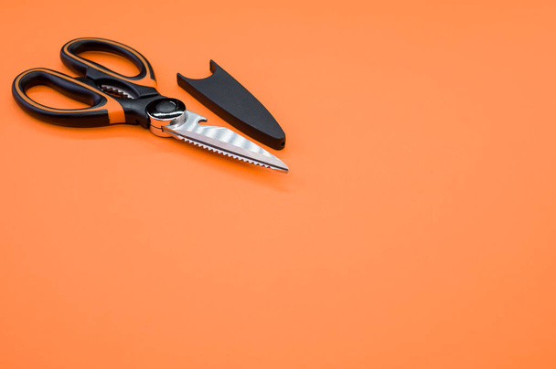 A closeup shot of scissors isolated on pink background. Cutting tool with zigzag blades, copy space - Fotografie, Obrázek