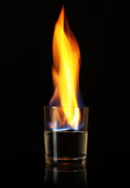 Glass with burning alcohol on black background - Foto, Imagem