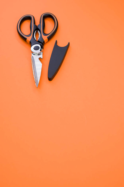 A vertical shot of scissors isolated on pink background. Cutting tool with zigzag blades, copy space - Photo, Image