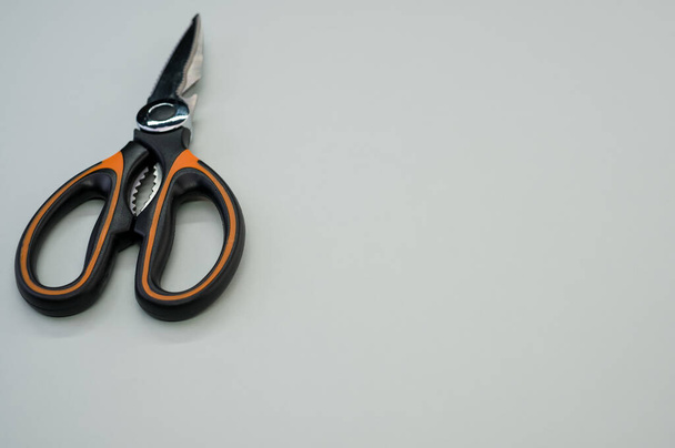 A closeup shot of scissors isolated on blue background. Cutting tool with zigzag blades, copy space - Foto, afbeelding