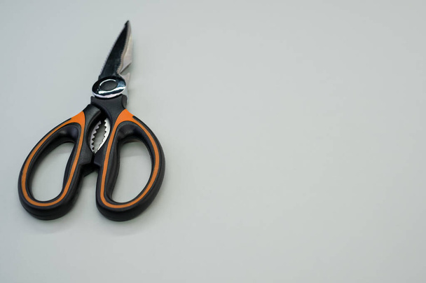 A closeup shot of scissors isolated on blue background. Cutting tool with zigzag blades, copy space - 写真・画像