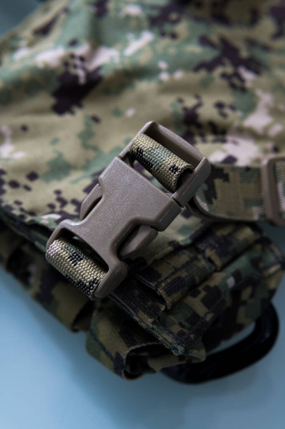 A vertical closeup shot of a clasp on military gear - 写真・画像