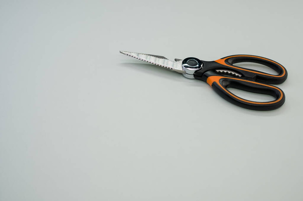A closeup shot of scissors isolated on blue background. Cutting tool with zigzag blades, copy space - Fotó, kép